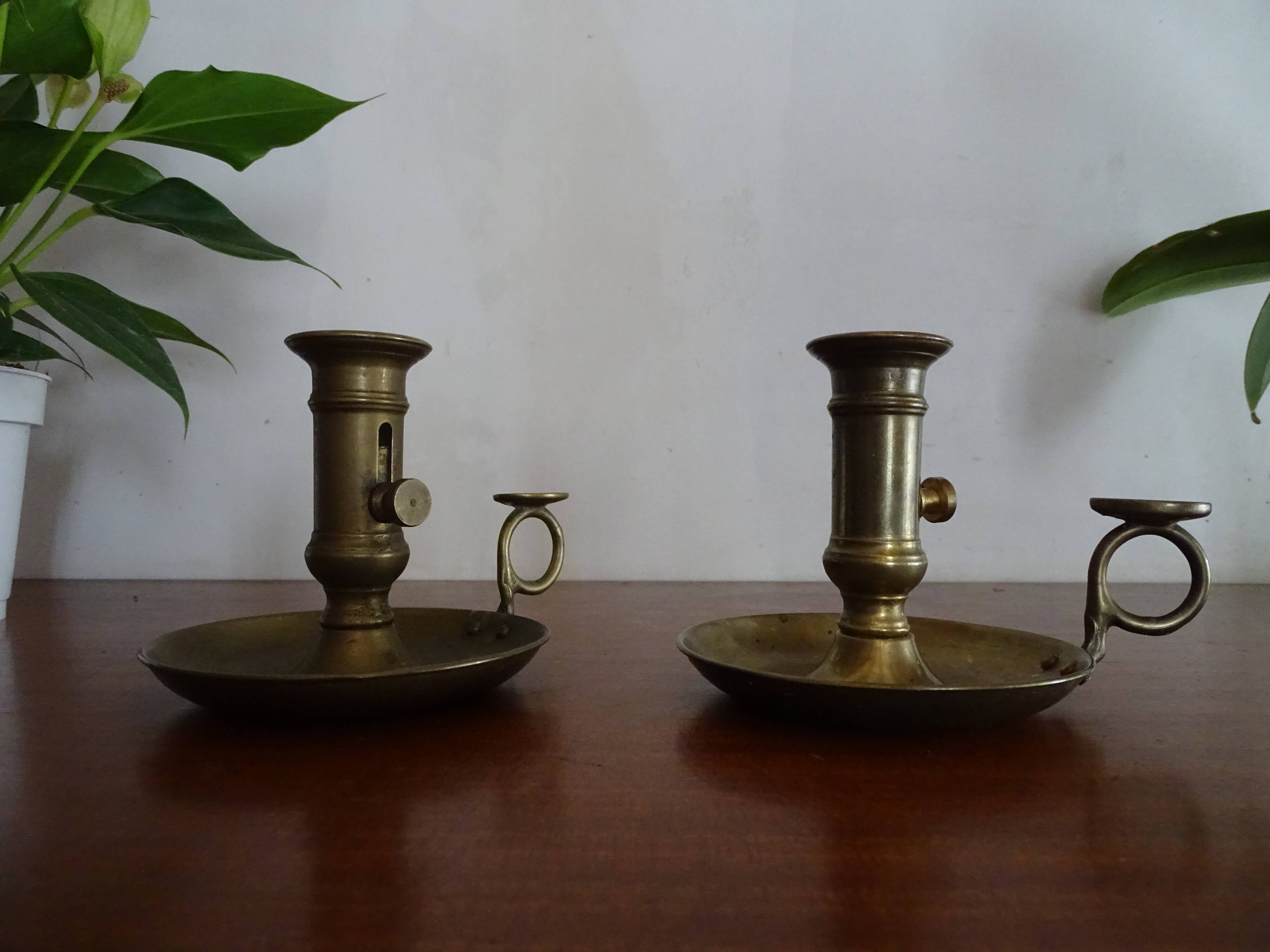 Pair of vintage brass pusher candle holders