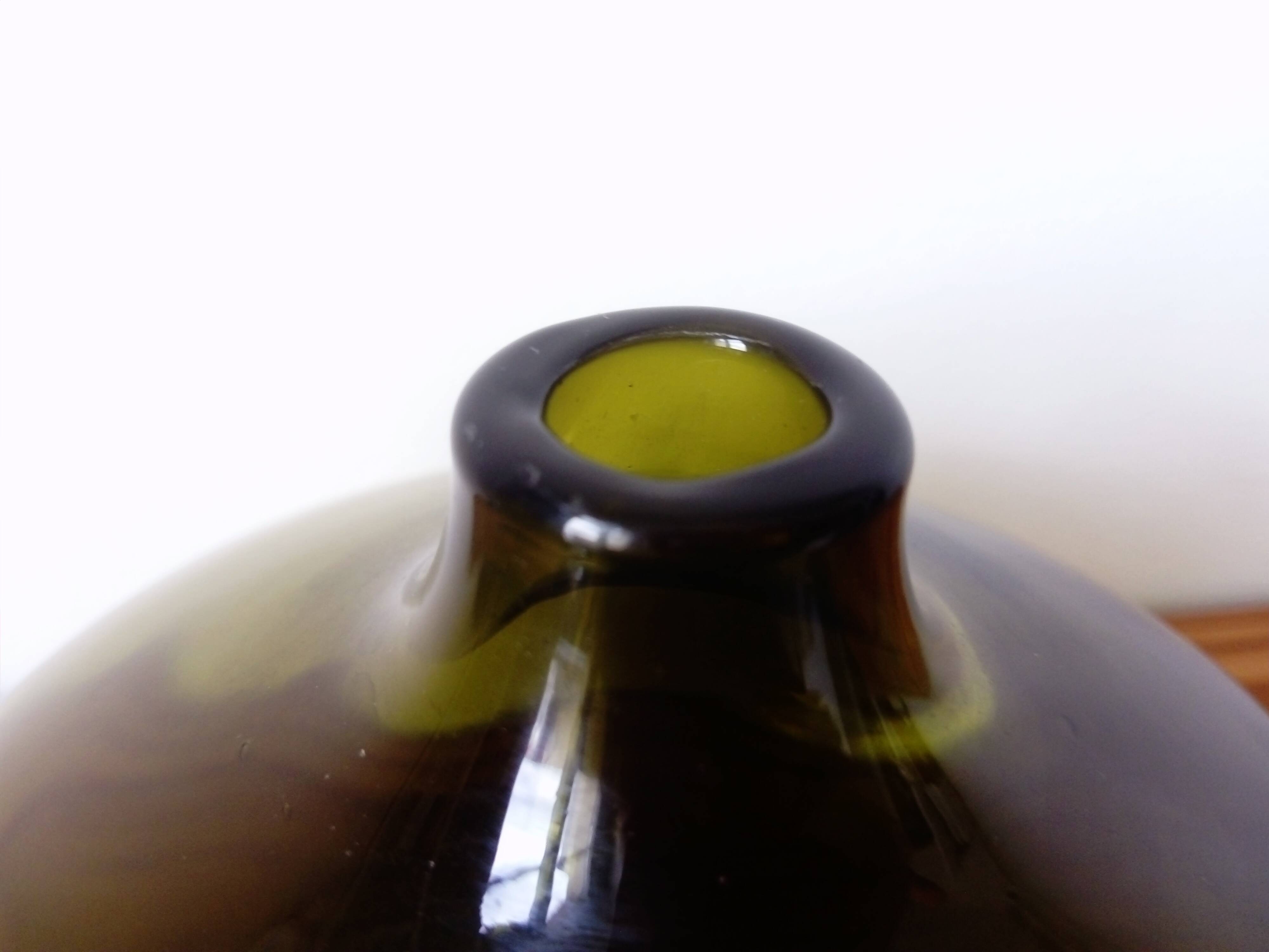 Small dark green handmade glass ball vase