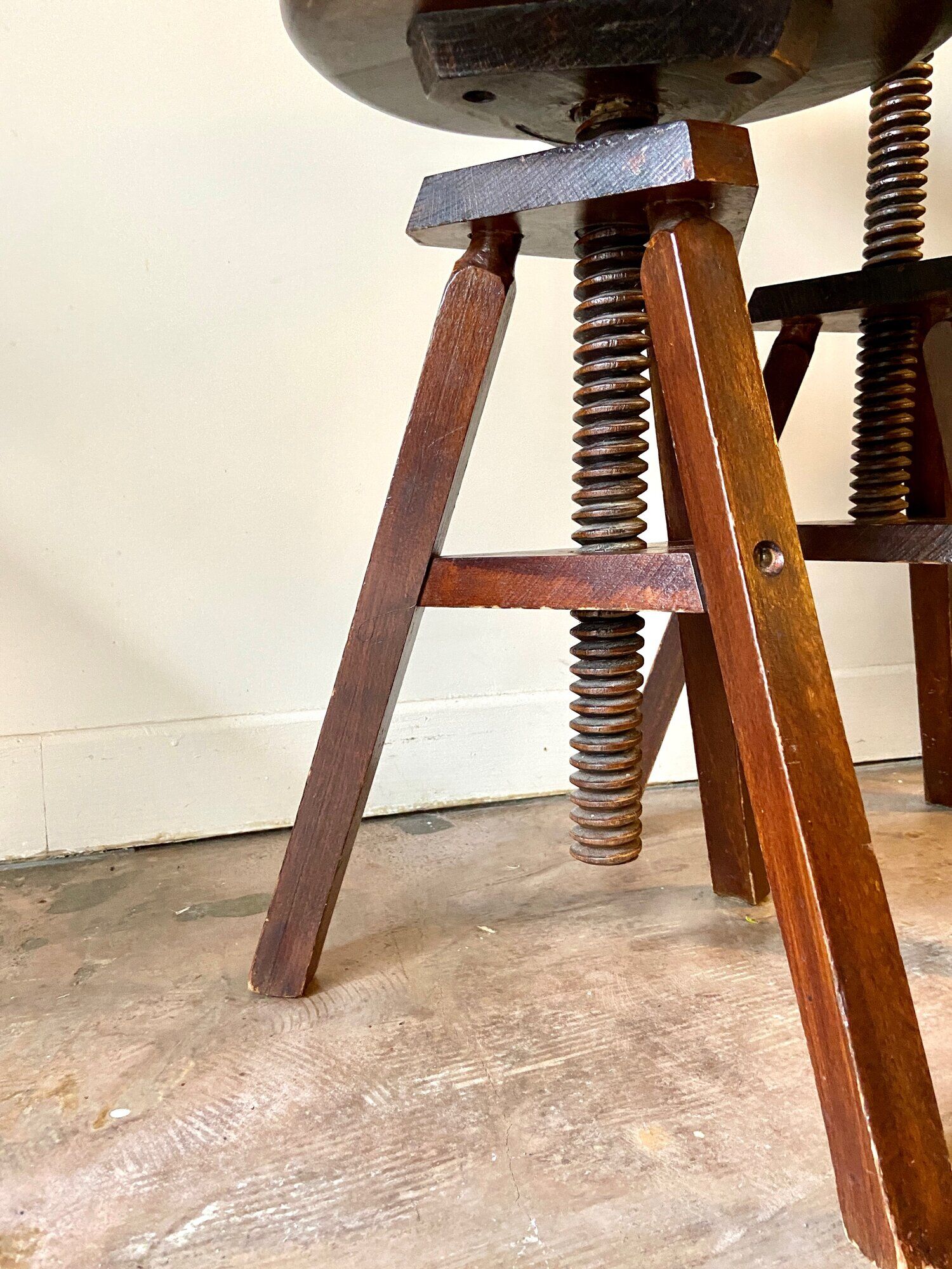 2 tripod stools with dark wood screws