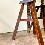 2 tripod stools with dark wood screws