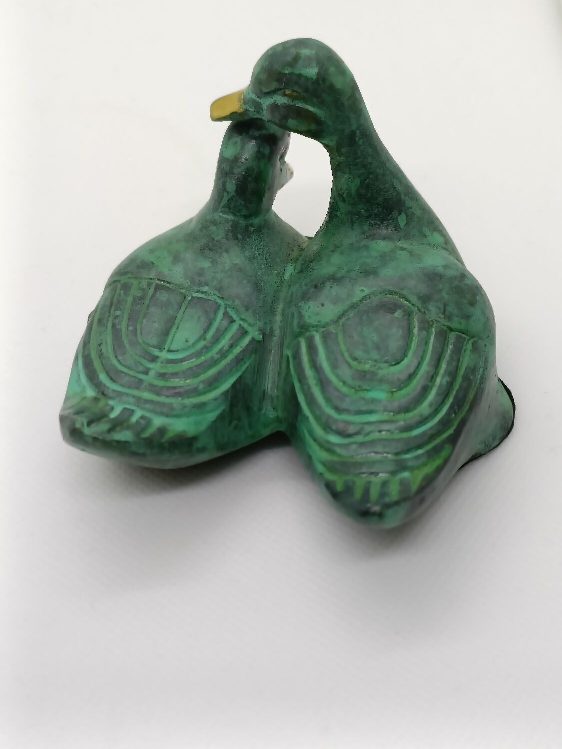 Two green and golden ducks in brass