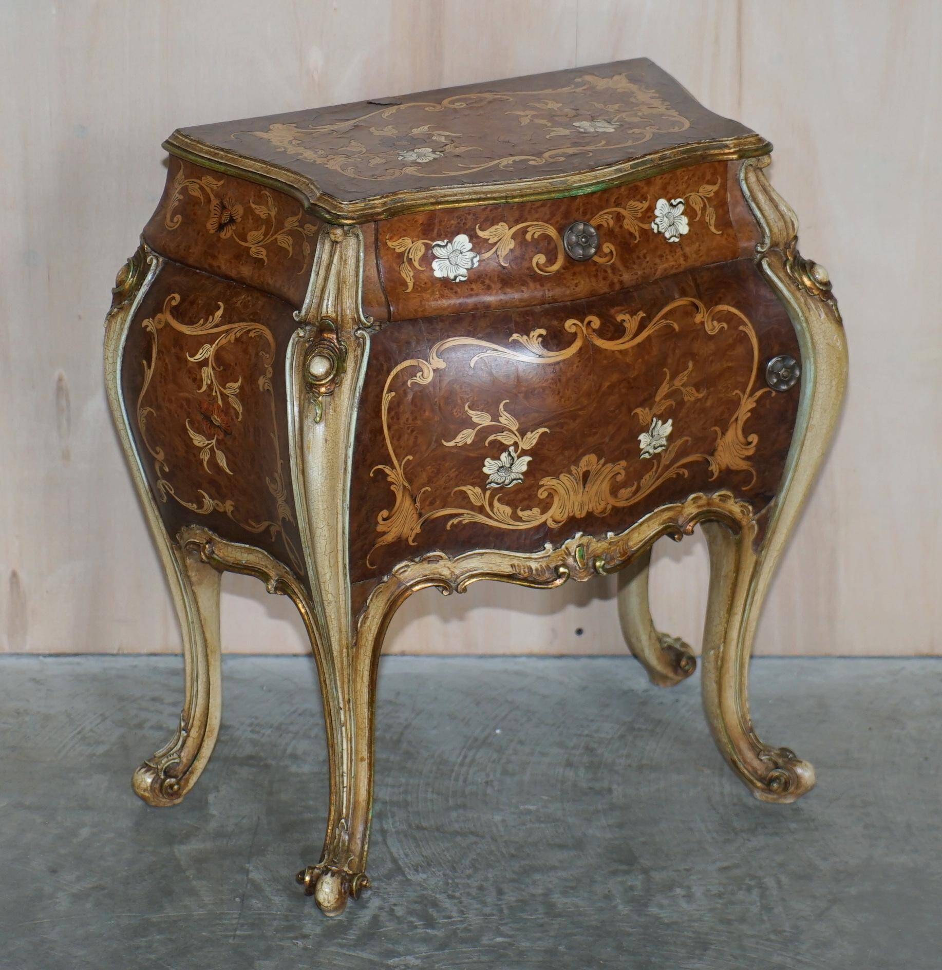 Pair of curved walnut commodes with marquetry and marble tops.