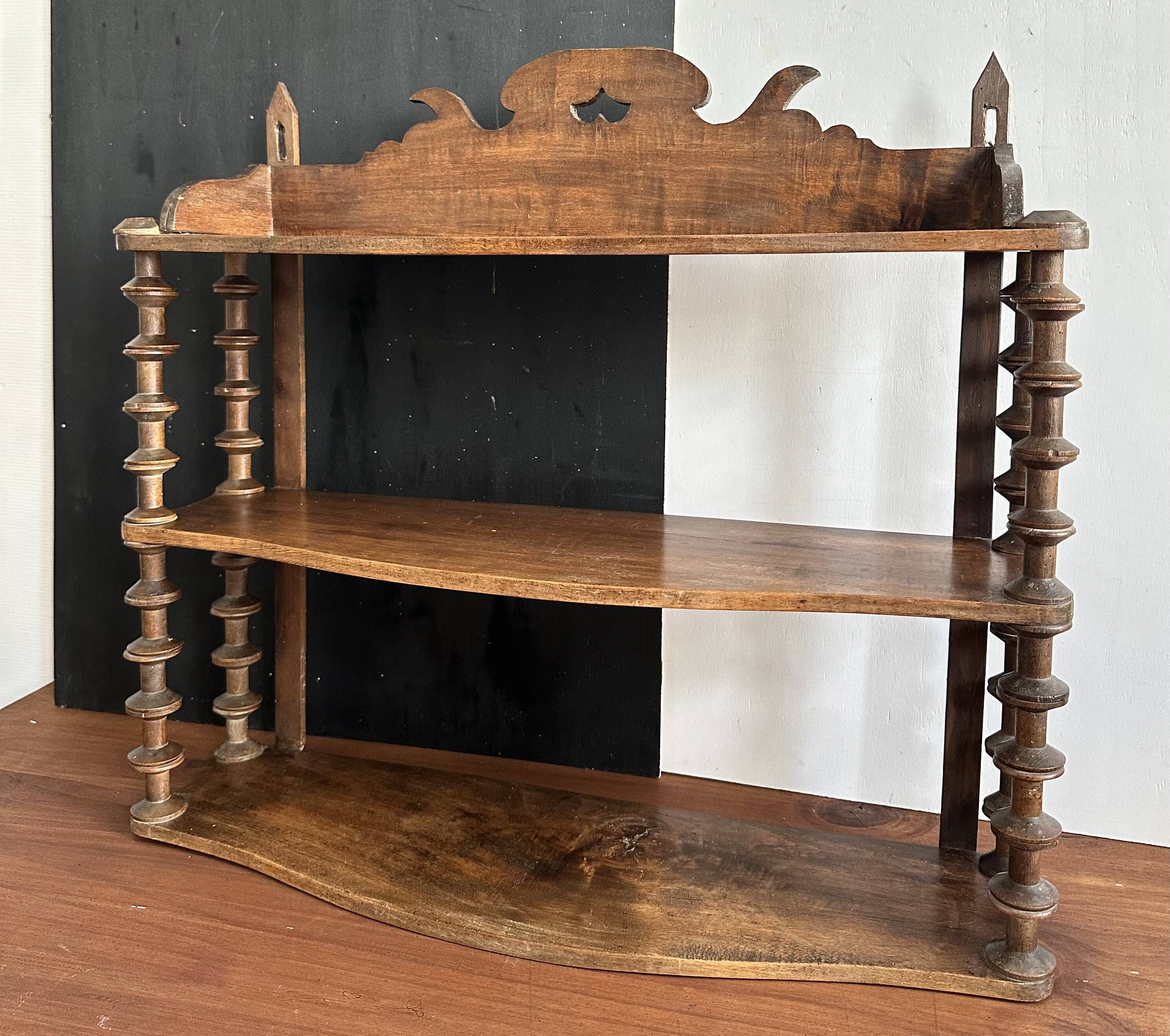 Antique wall shelf made of turned wood and spools of thread, late 19th century.