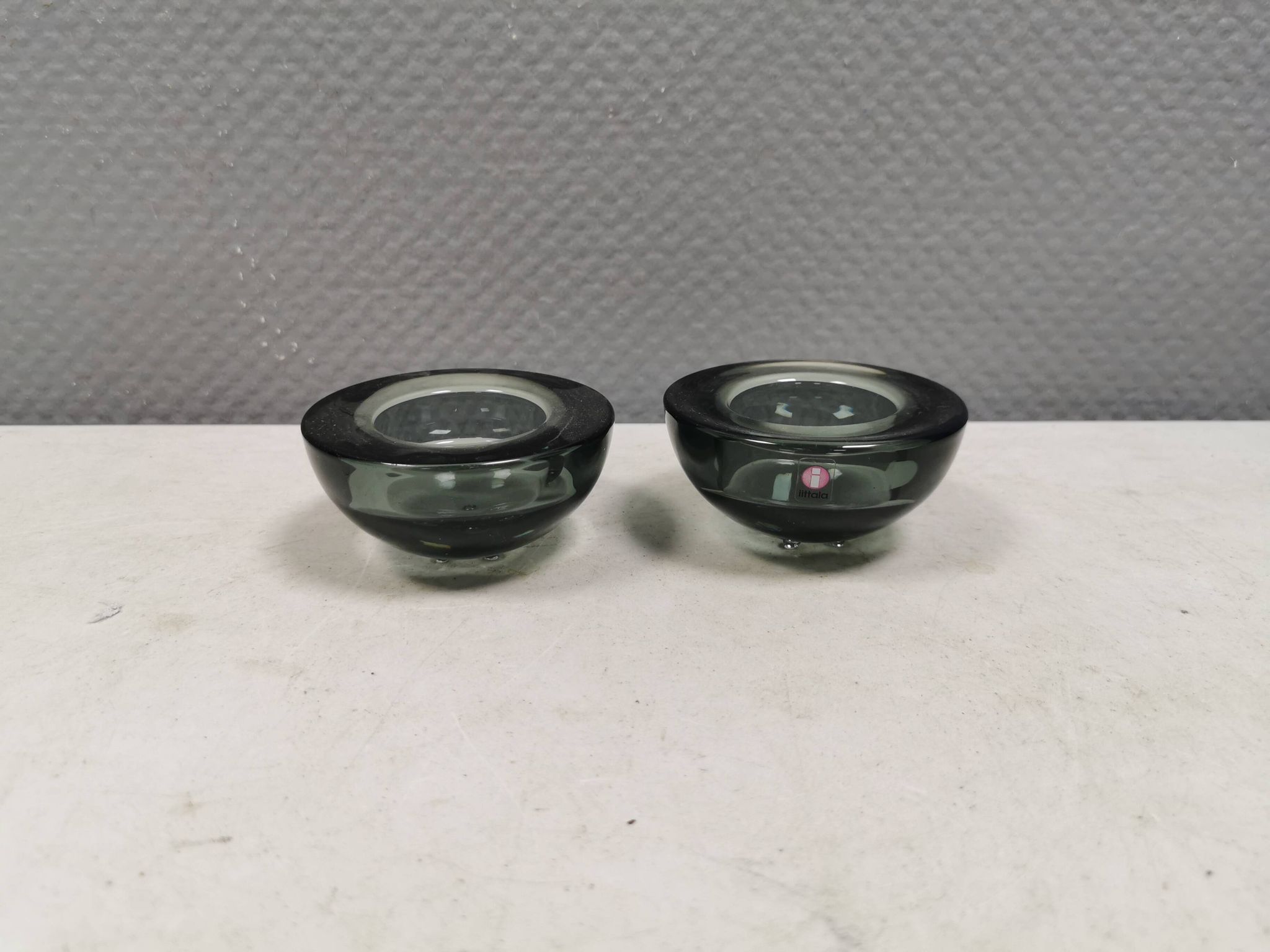 A set of iitalla candle holders in smoked transparent glass.