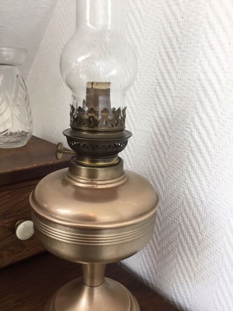 Old oil lamp on pink copper stand