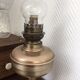 Old oil lamp on pink copper stand