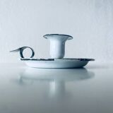 Old candle holder in white enameled metal