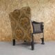Old armchair upholstered in velvet, carved and caned wood