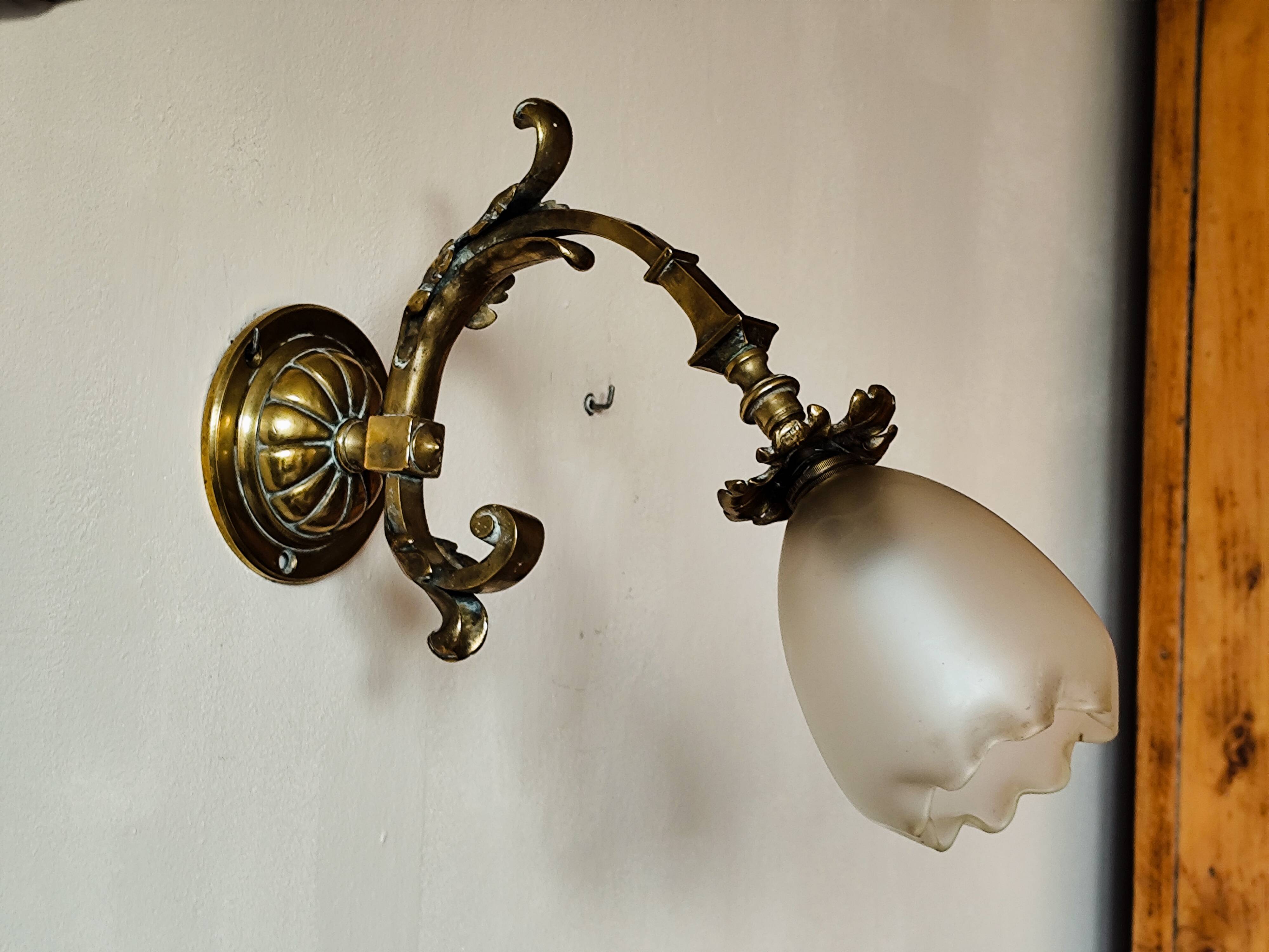 Bronze wall light with opaque glass tulip