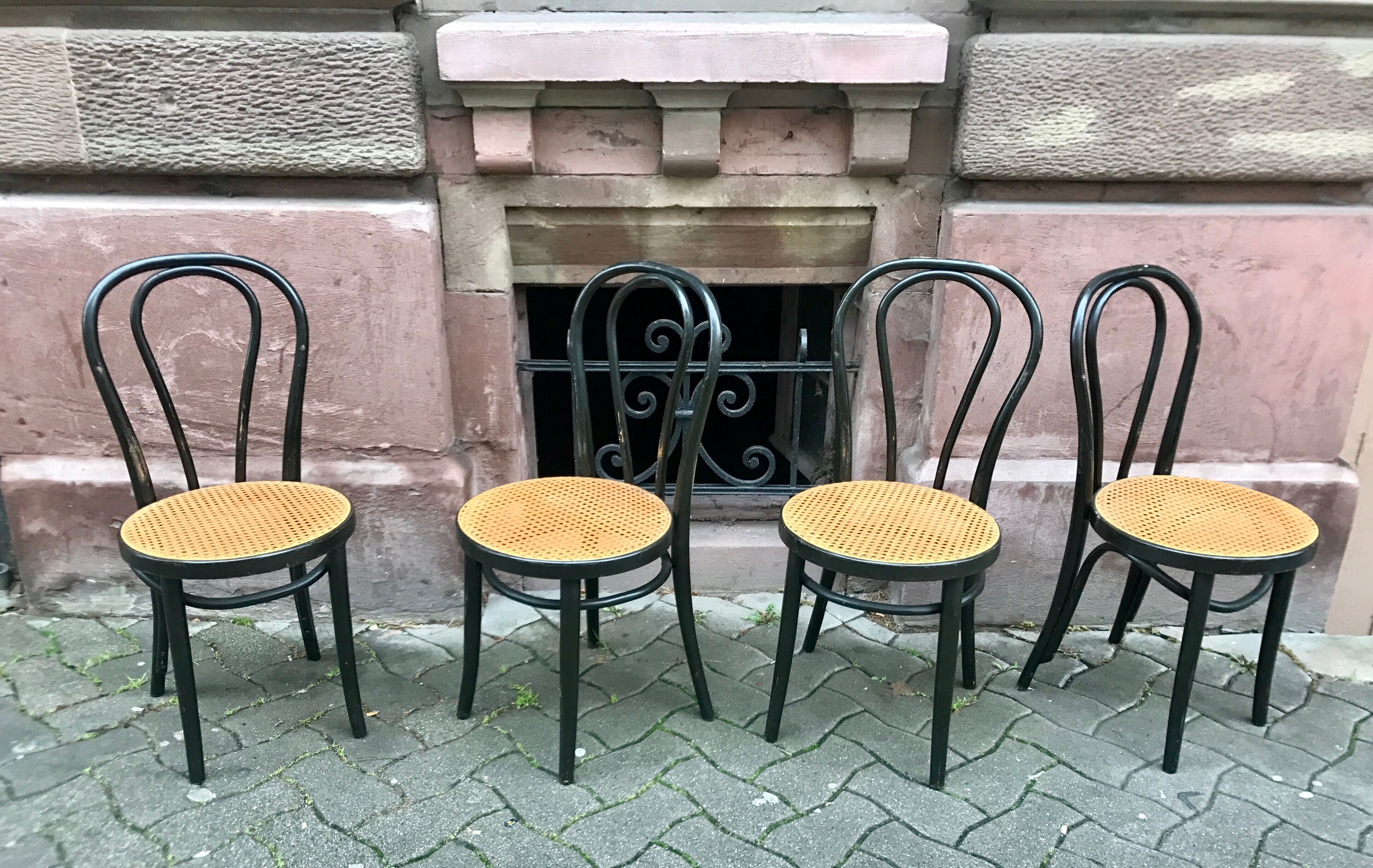 Two pairs of black 50s chairs - number 18 - cannée
