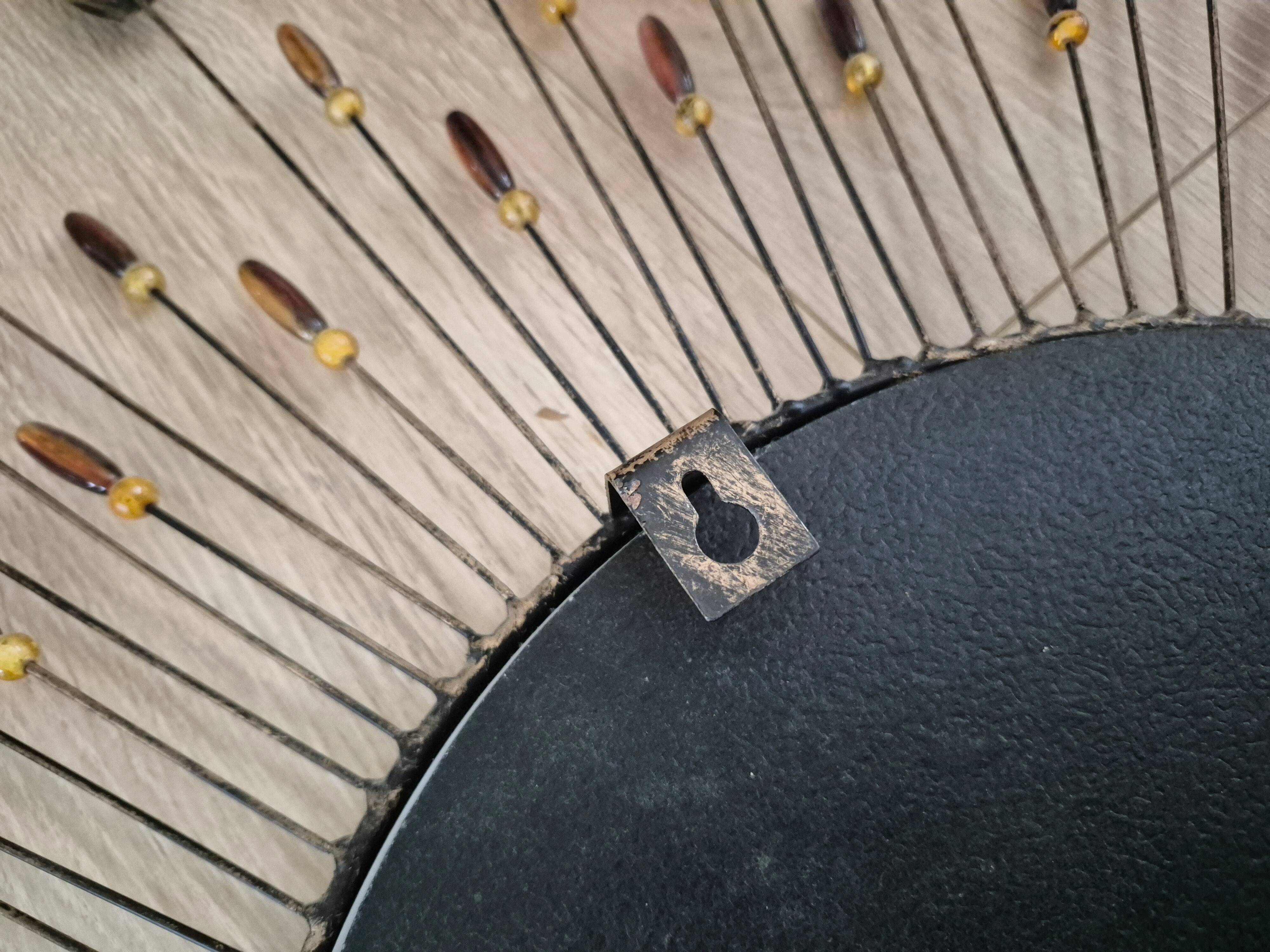 Vintage metal sun mirror in the style of Line Vautrin