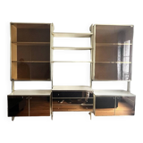 Wall-mounted and modular bookcase in lacquered brass, mirrors and smoked glass by Mahey, Design 1970