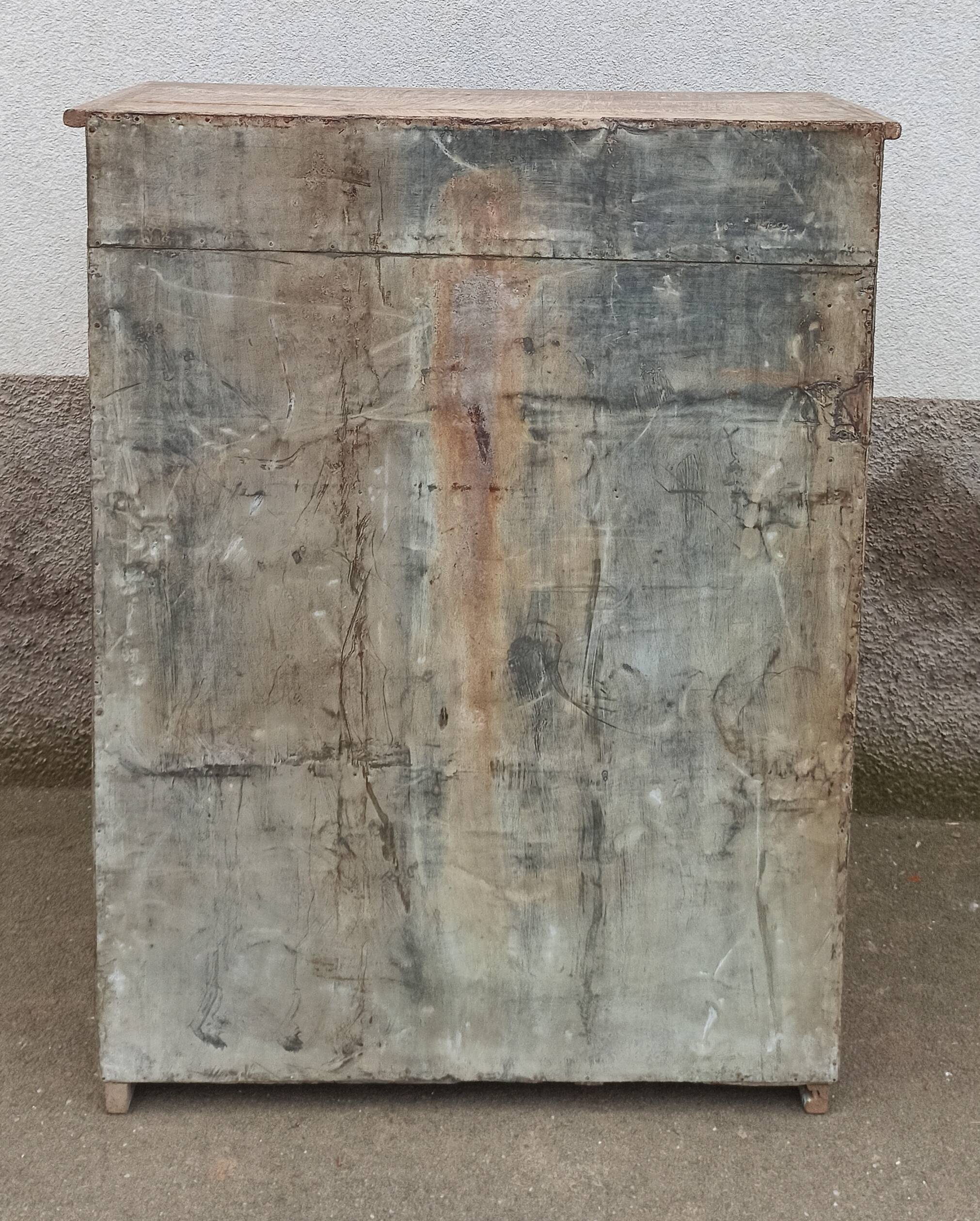 Old glazed wooden cabinet with metal bottom