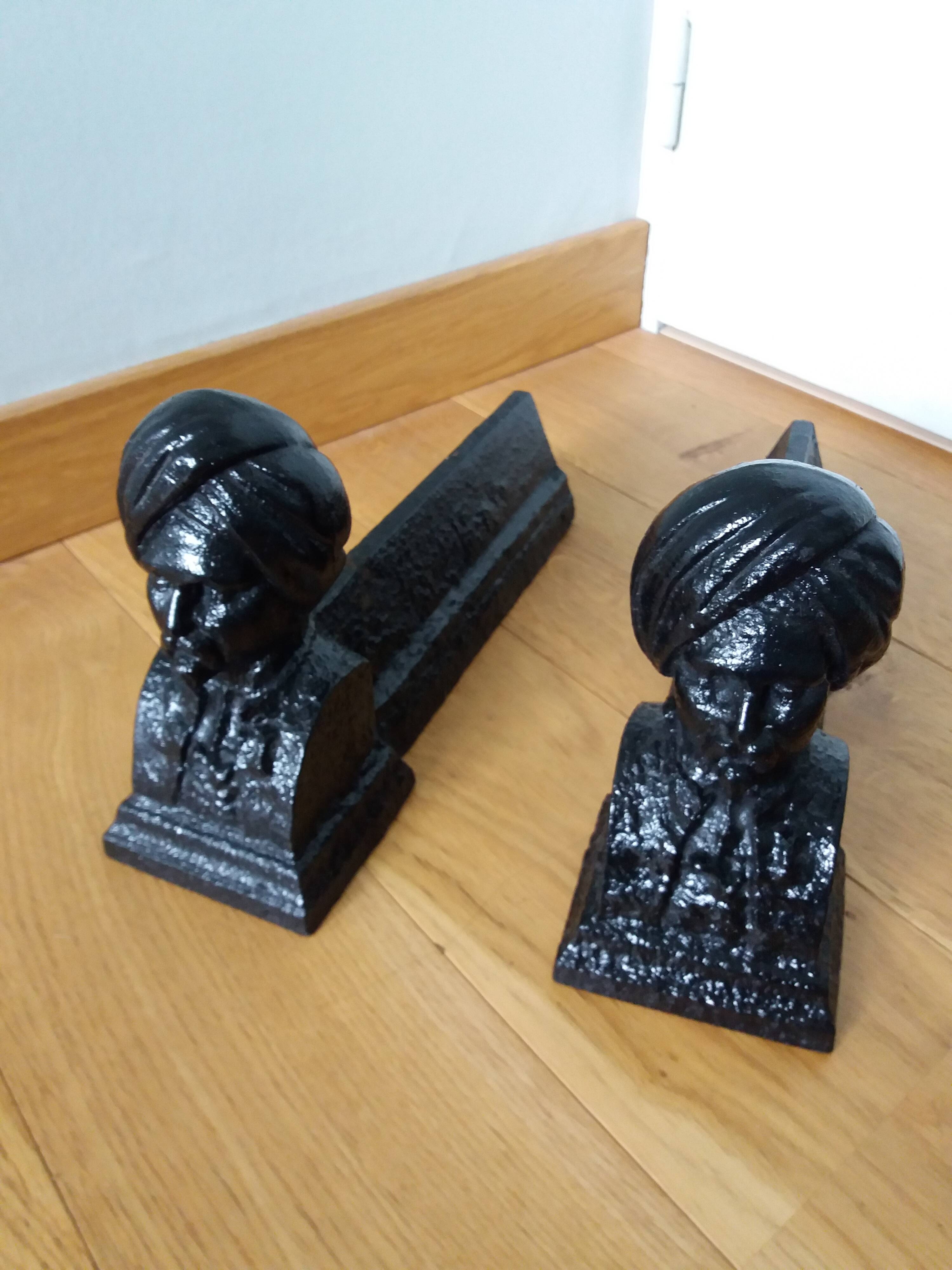 Cast iron andirons with character heads