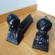 Cast iron andirons with character heads