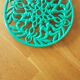 Green enamelled cast iron table mat