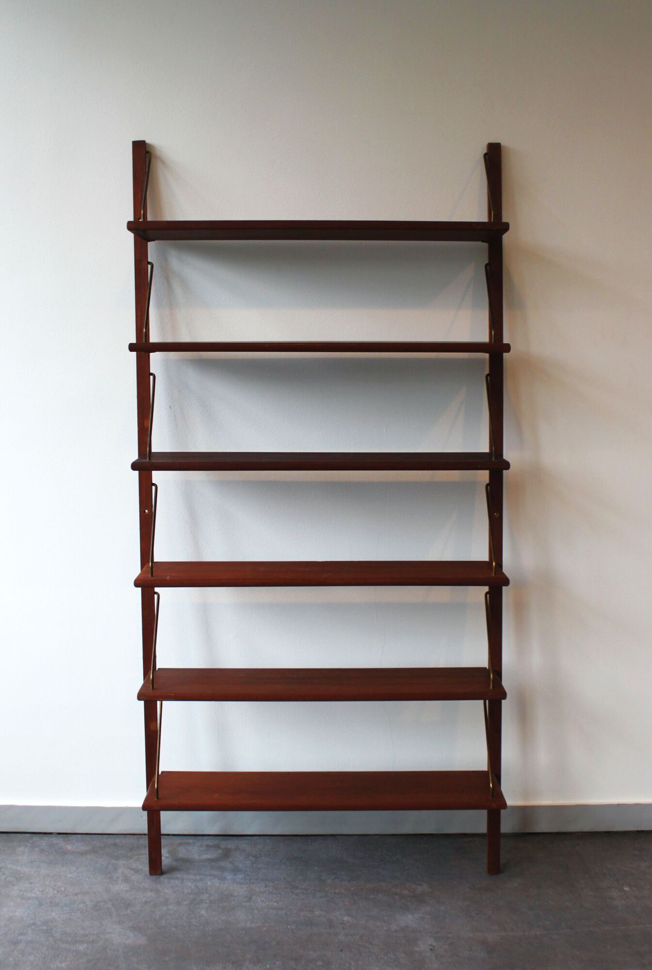 Teak and brass wall shelf by Poul Cadovius for Royal System, Denmark, 1960.