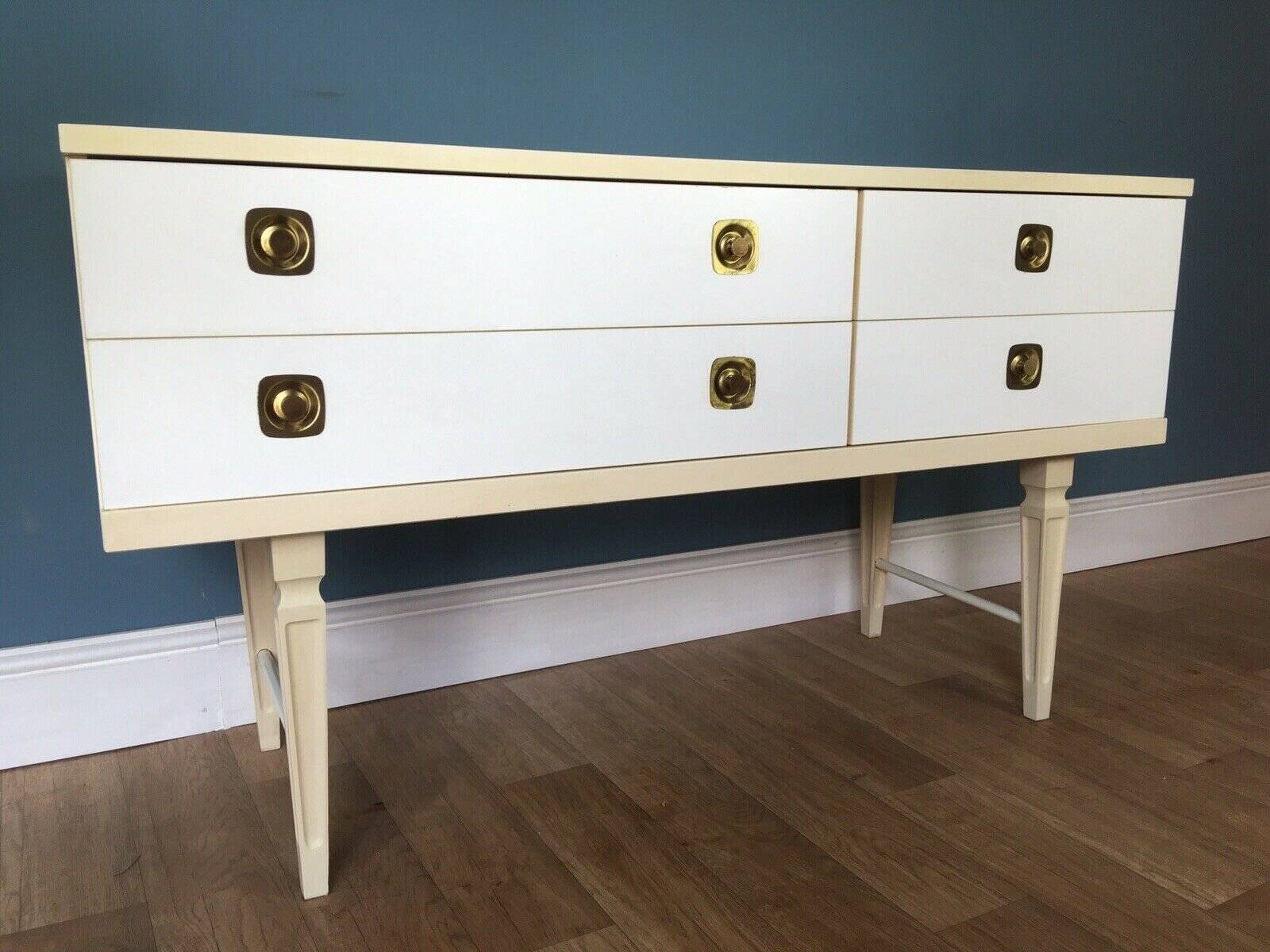 White retro wooden commode in Mid-Century style, tapered legs and gold handles (1960s)