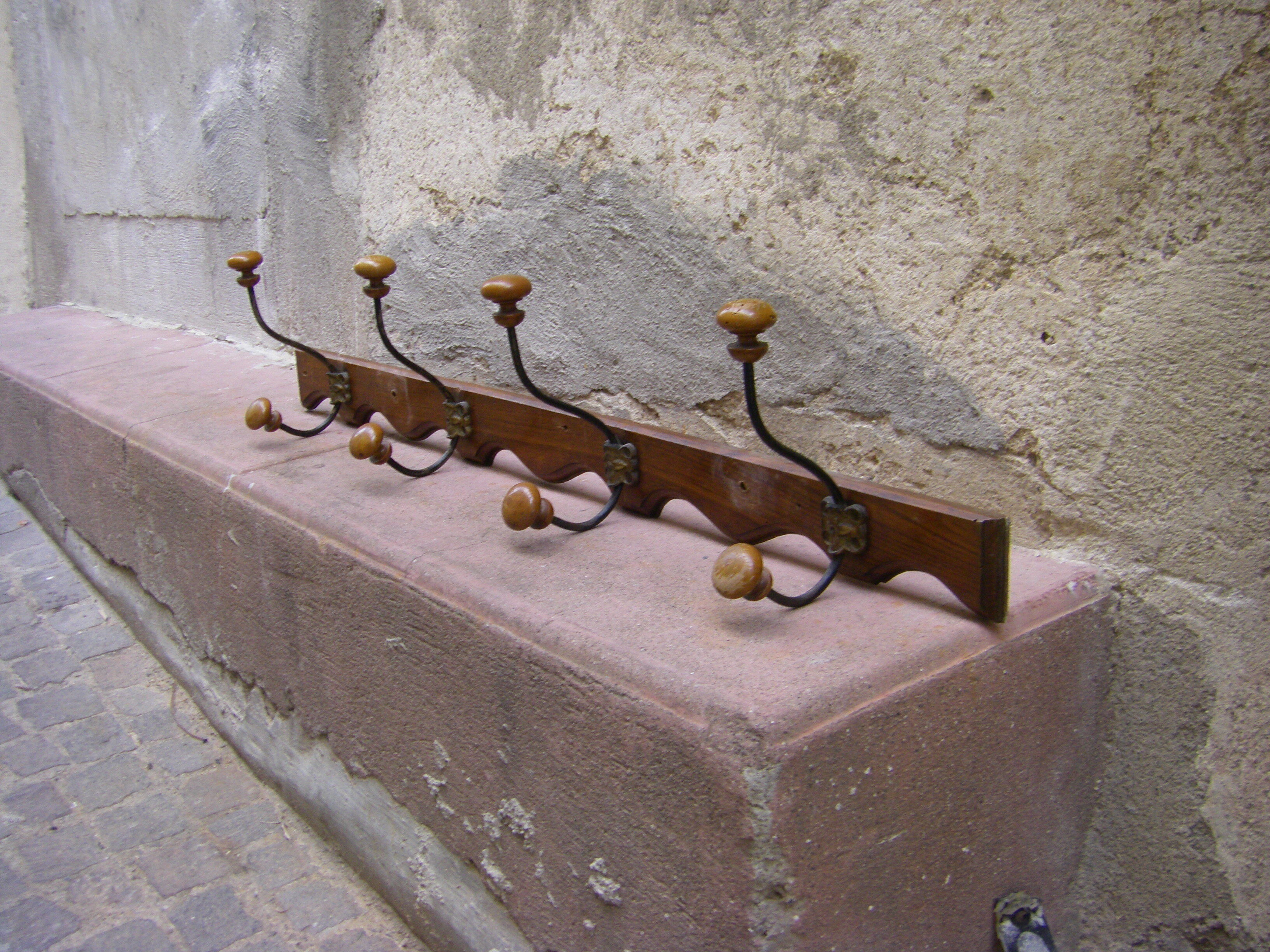 Wall coat rack has four hooks