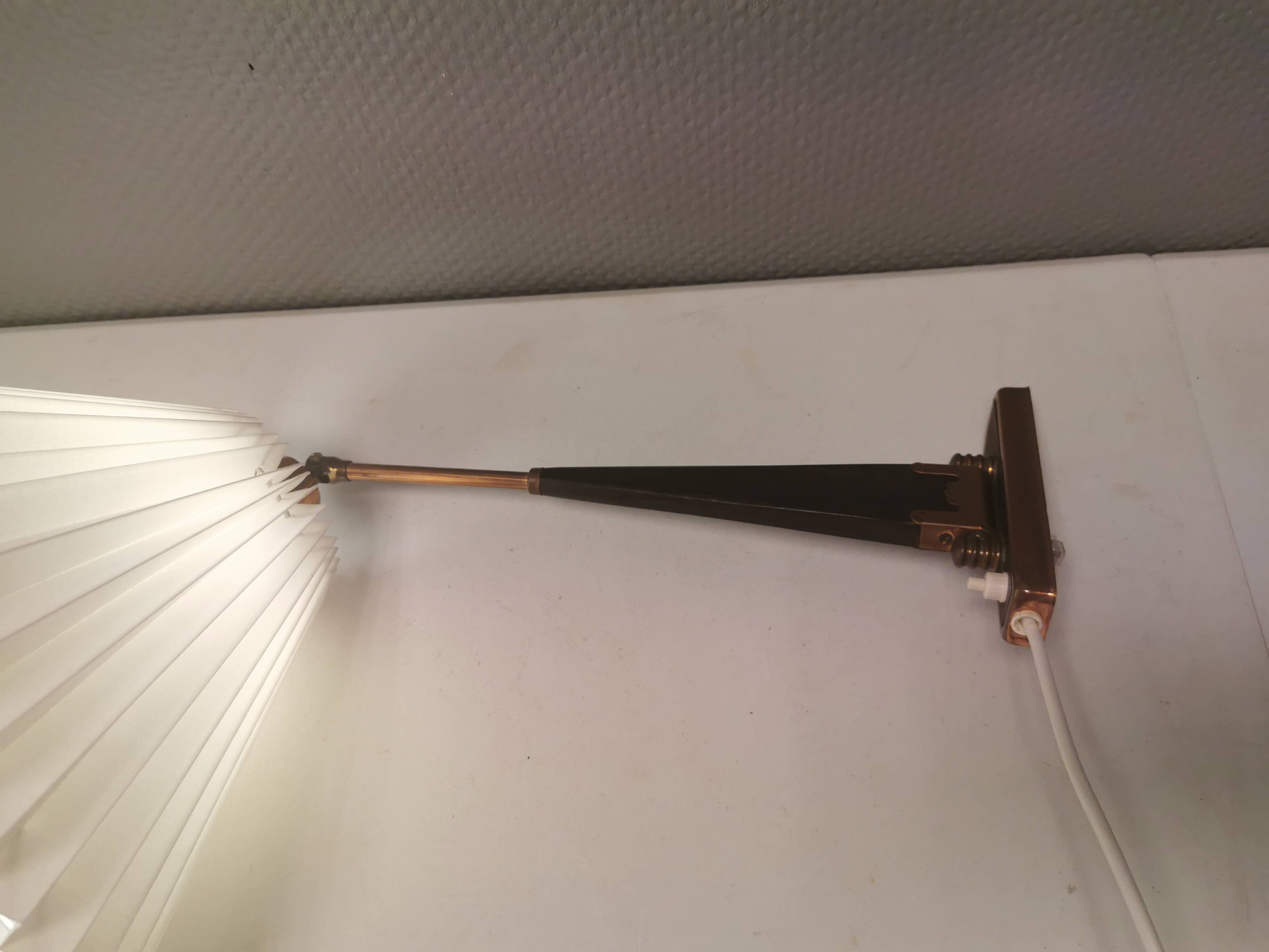 Wall lamp with adjustable ‘arm’ in copper and rosewood, with white shade.