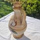 Handcrafted jug or jar with a handle, terracotta pottery vase, fat lava effect, stylized flowers