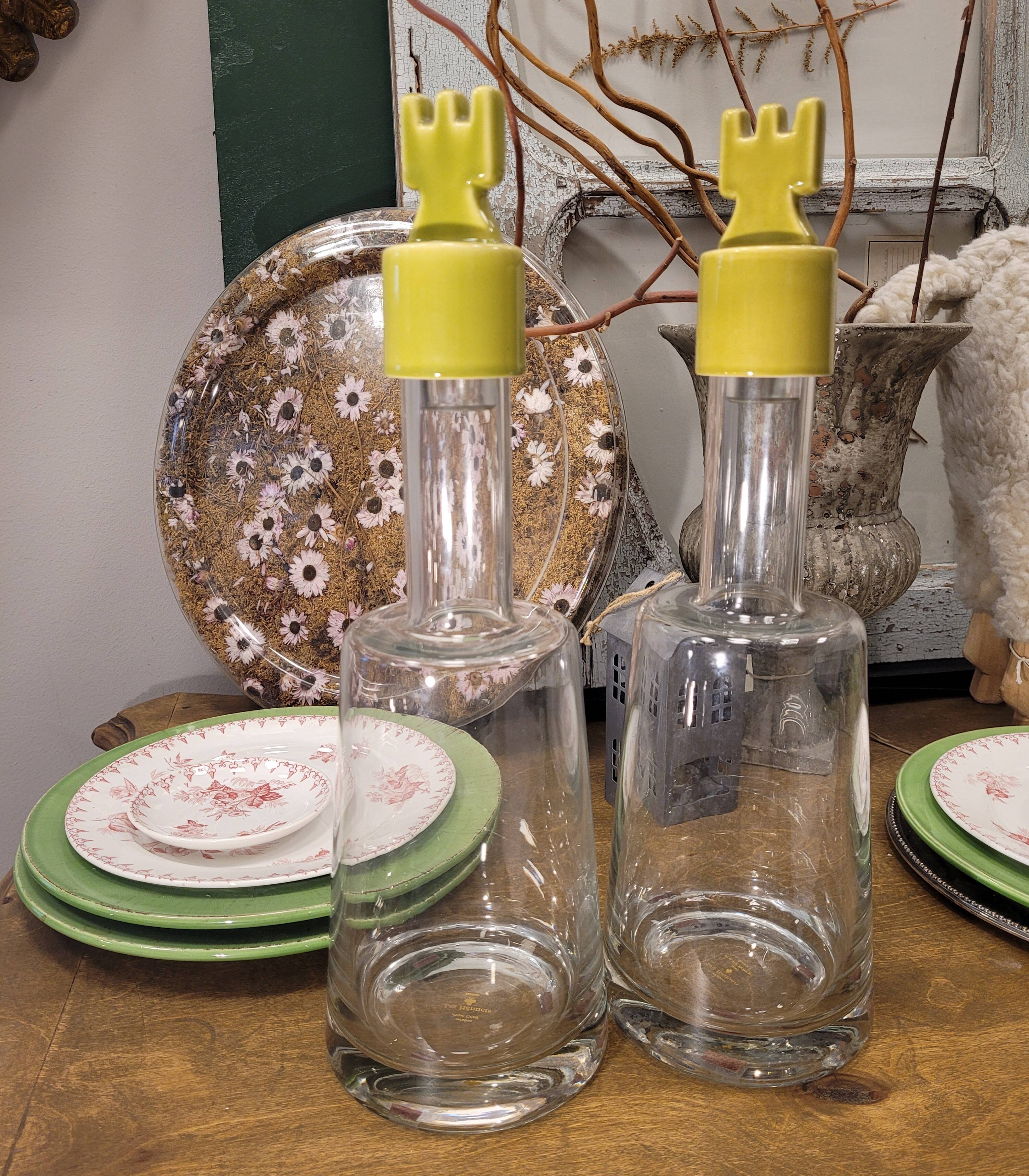 pair of decanters, bottles or jars, made in crystal with a ceramic tap enameled in green color