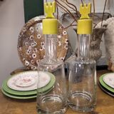 pair of decanters, bottles or jars, made in crystal with a ceramic tap enameled in green color