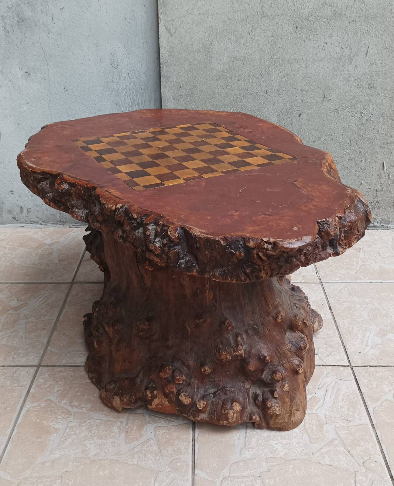 Brutalist chessboard coffee table made from tree stump.