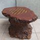 Brutalist chessboard coffee table made from tree stump.