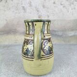 Glazed earthenware pitcher signed Riou.