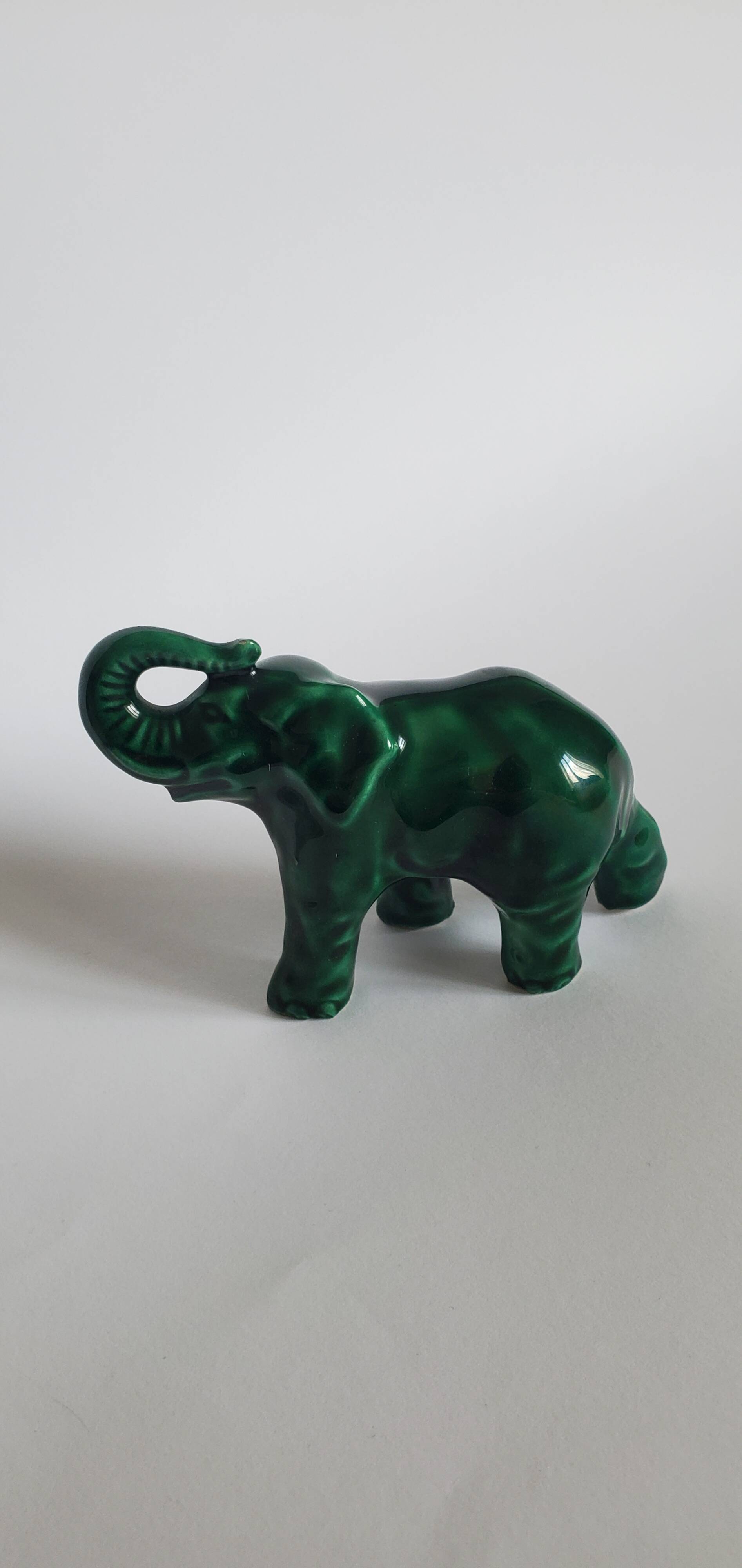 Small emerald green ceramic elephant.