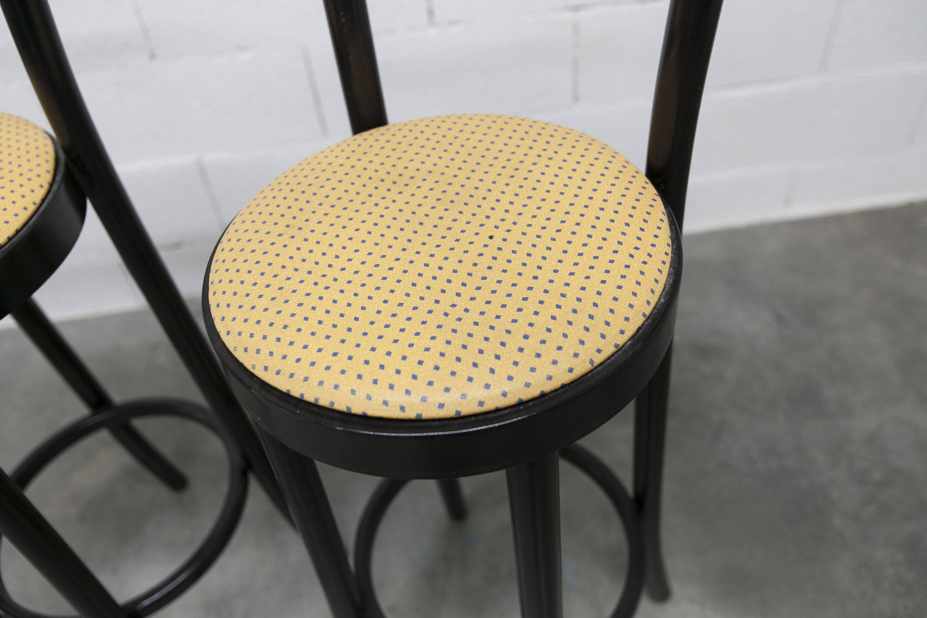 Pair of Baumann Dialog model stools in black and yellow and blue imitation leather, 1990