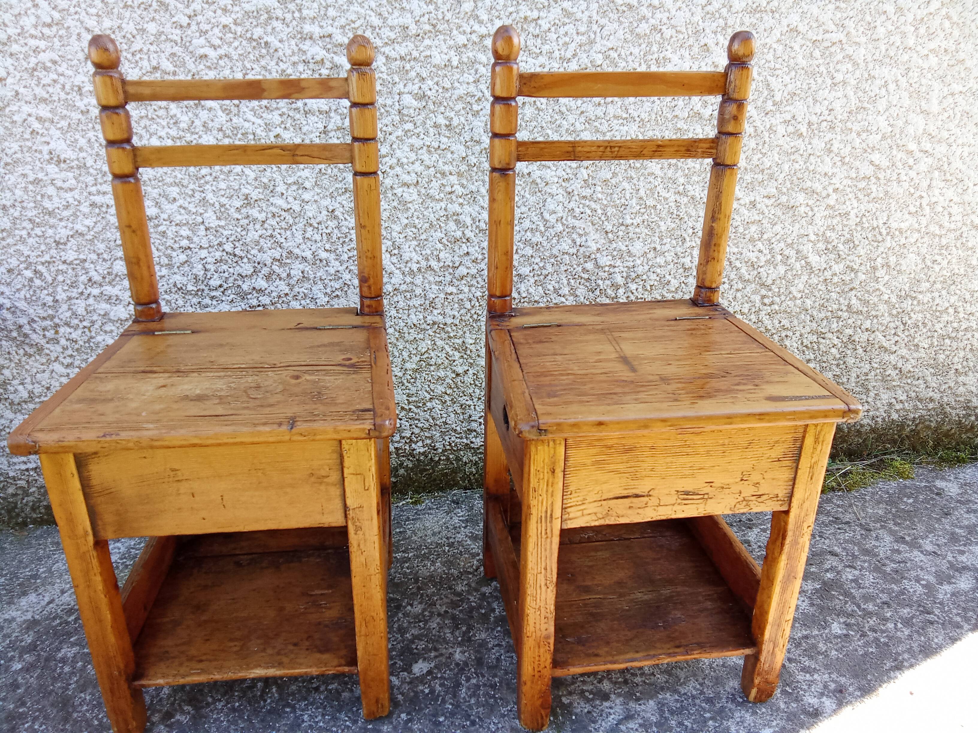 2 old wooden children's chairs with a small chest.