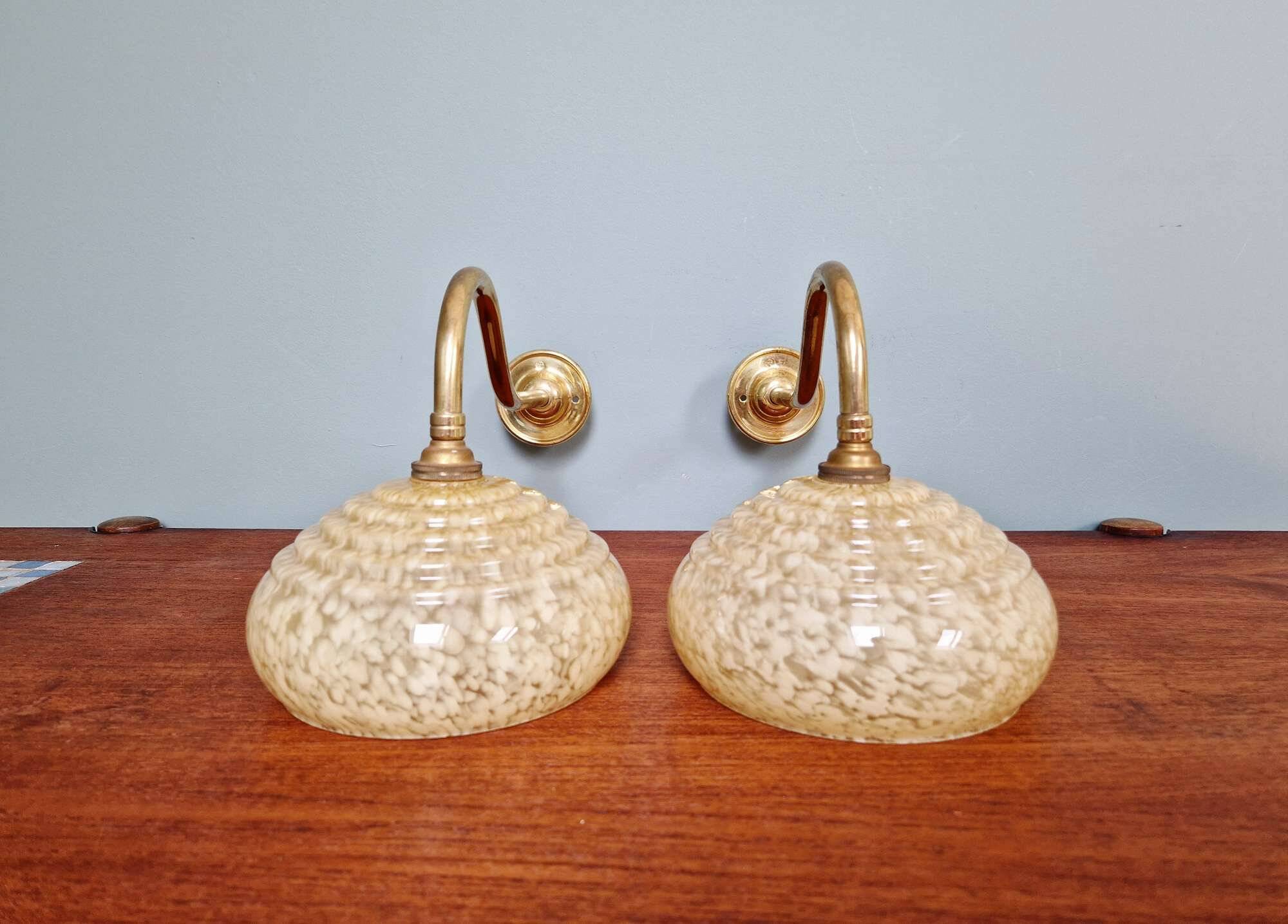 Pair of brass and yellow/white speckled glass wall sconces