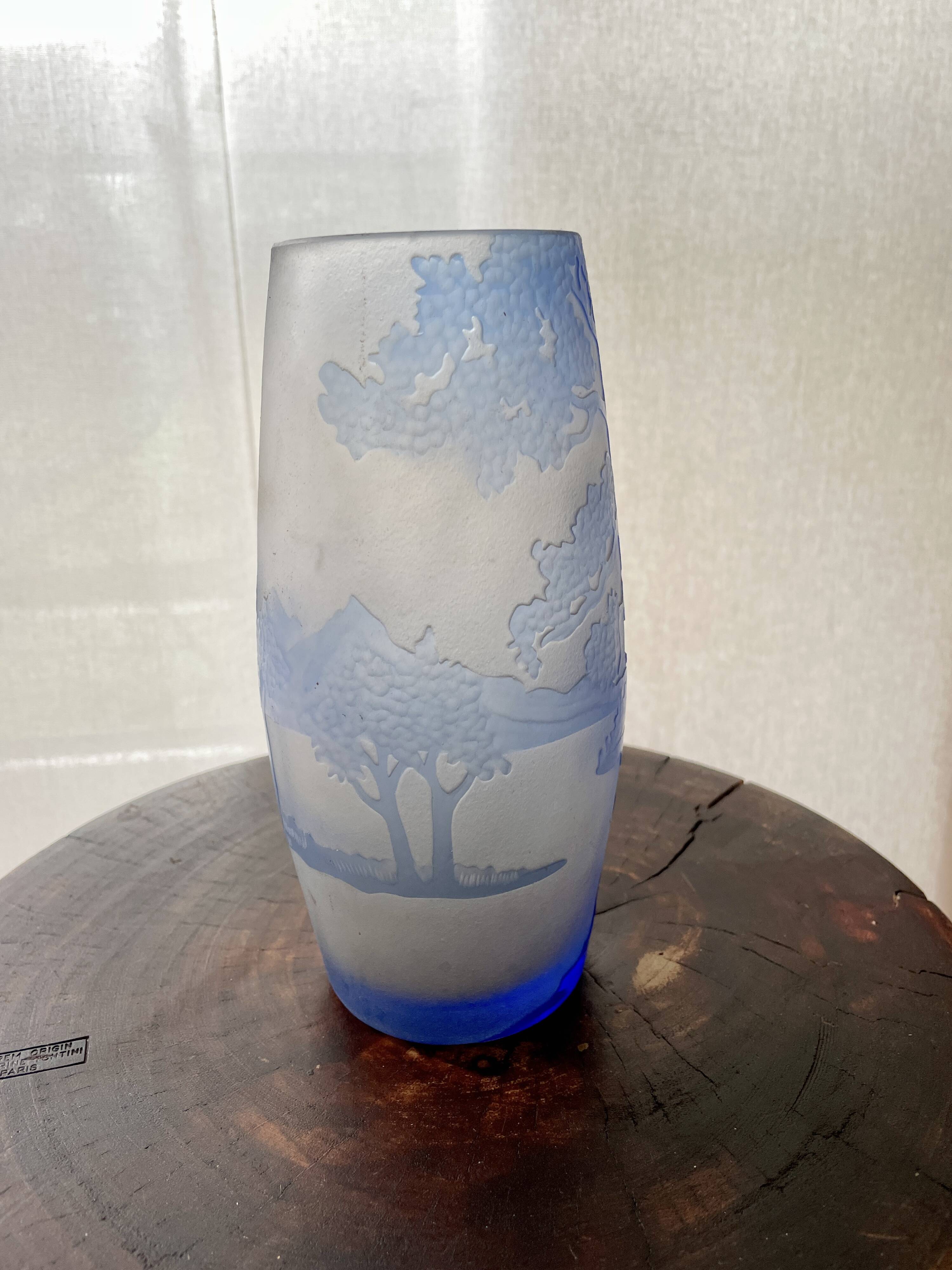 Transparent vase with a blue pattern featuring trees, signed MICHNA.