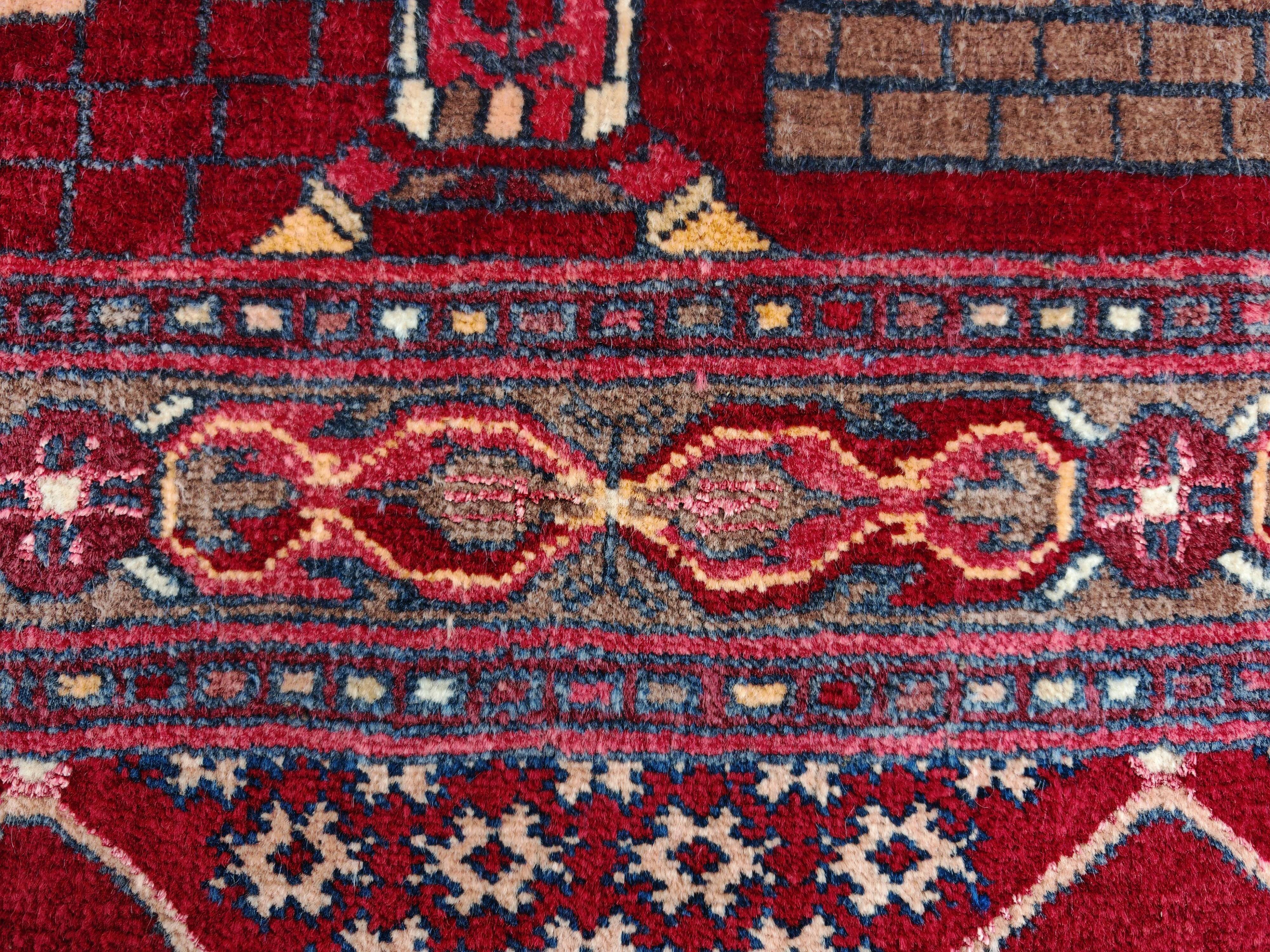 Vintage Afghan hand-knotted prayer rug with Islamic patterns.