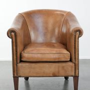 Characterful club chair made of sheepskin leather with light cognac colours