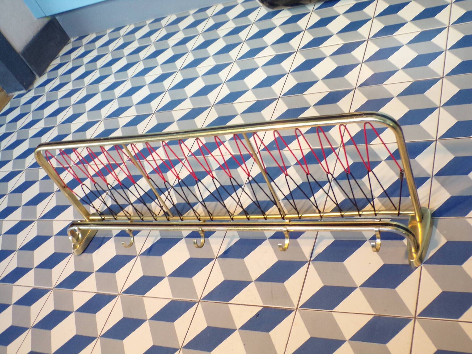 Coat rack styled like a train luggage rack, length = 81 cm.