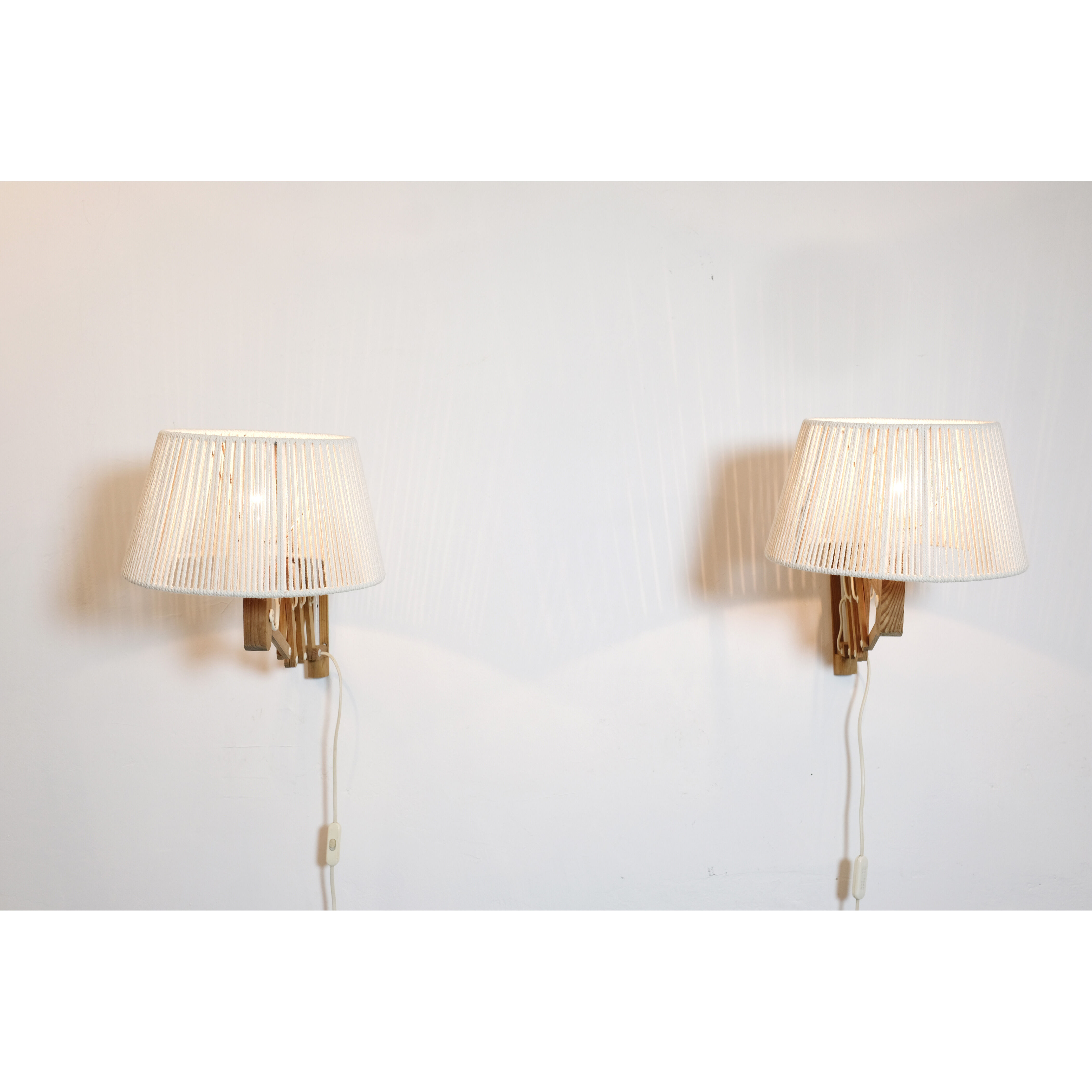 Pair of pine accordion sconces with cotton rope lampshade.