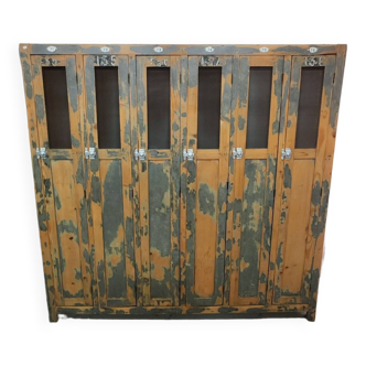 Old industrial wooden locker room with six doors, gray patina