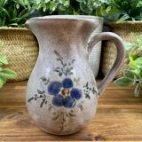 Vintage grey ceramic pitcher with hand-painted blue flower decoration.