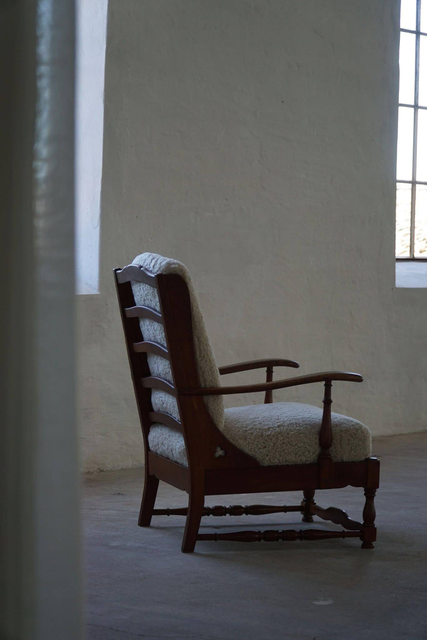 Modern Danish design, a pair of high-backed armchairs in oak and lambswool, 1950s.