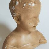 Bust of a small child in ancient plaster