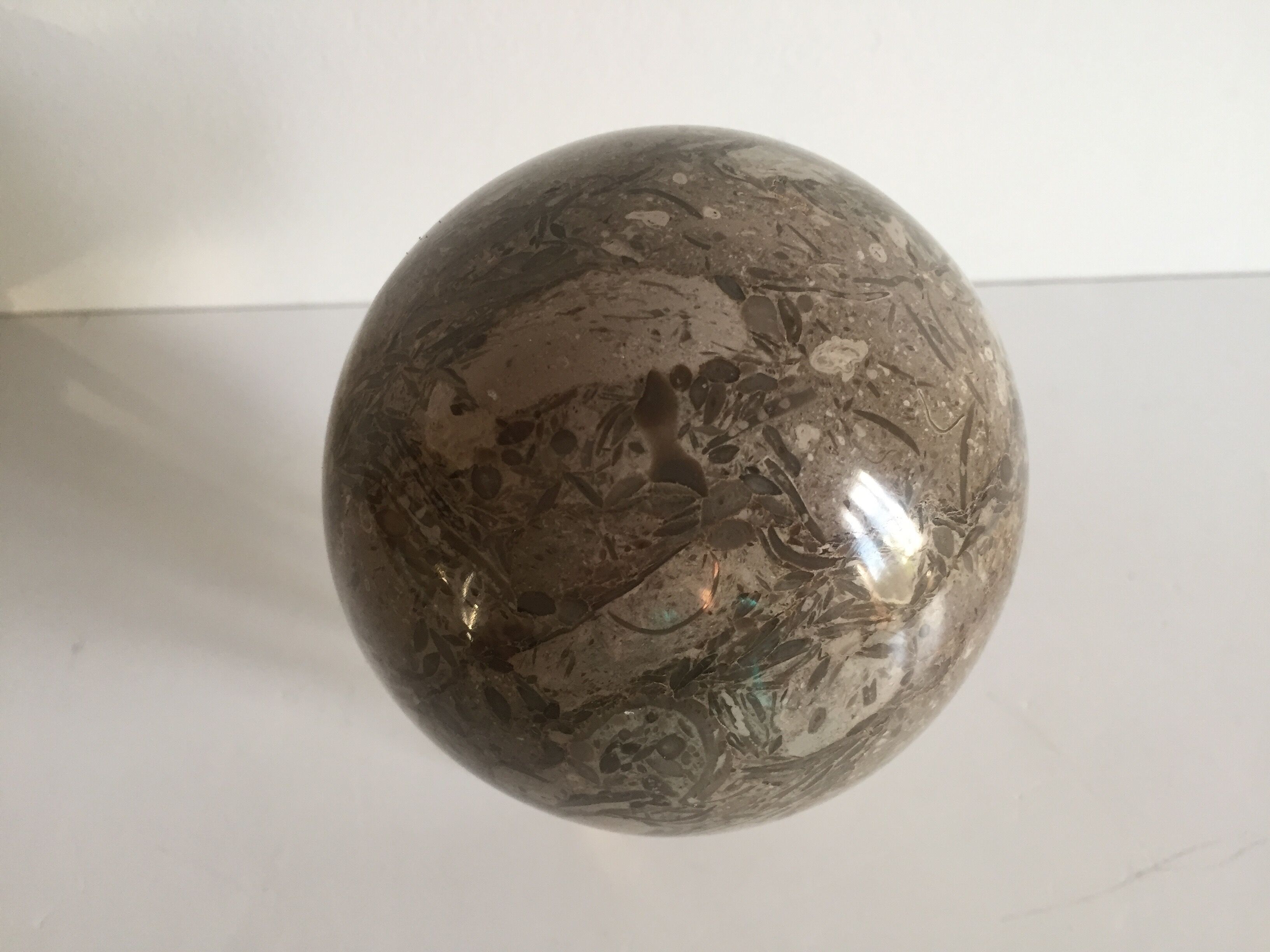 Marble ball paperweight on vintage brass