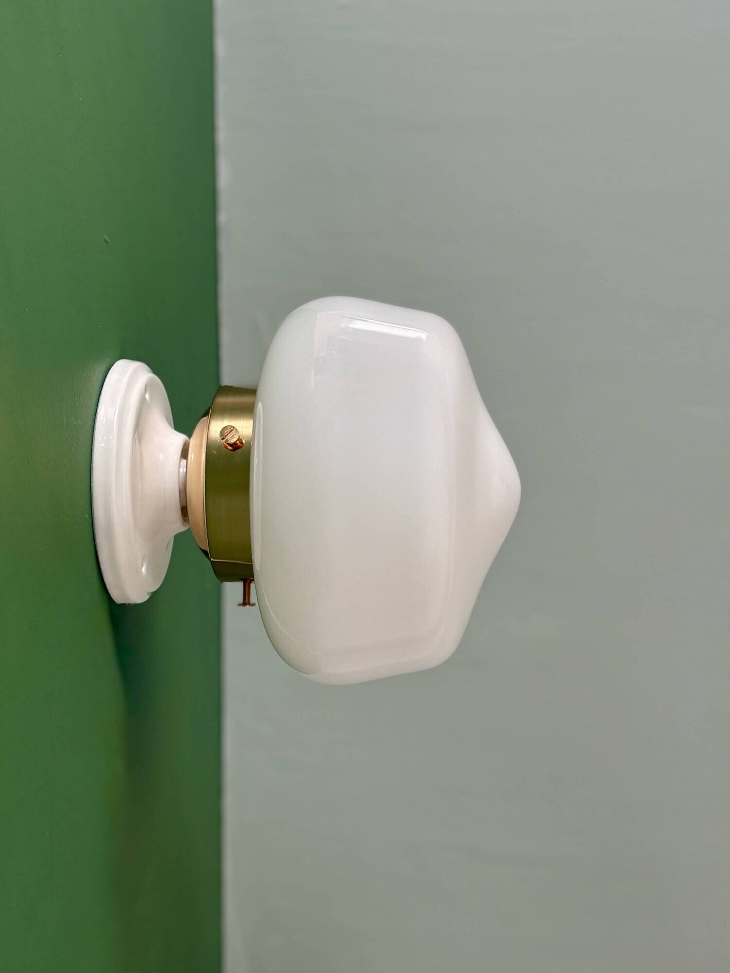 Vintage Art Deco globe wall light in white opaline.
