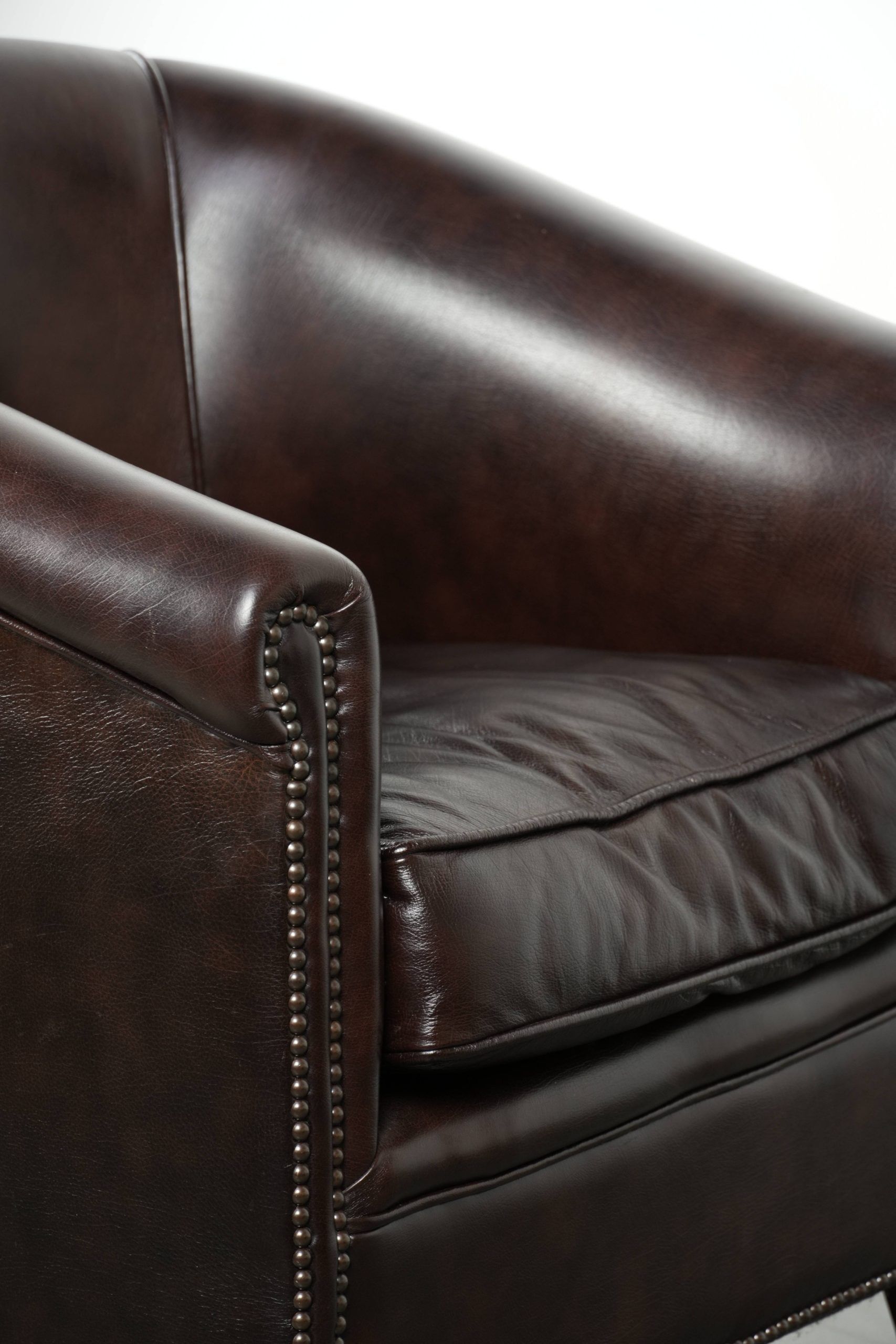 Dark cow leather club armchair with a stylish design in English style