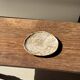 Small oval beige petrified wood dish or tray with speckled edges.