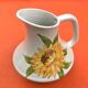 Antique glazed ceramic pitcher with sunflower decoration