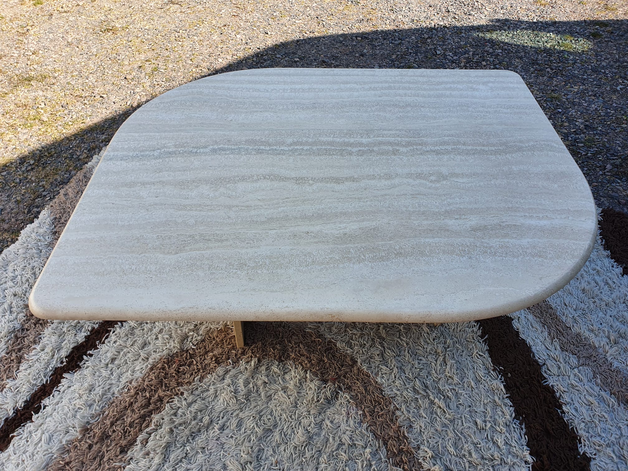 Adjustable travertine coffee table eye shape