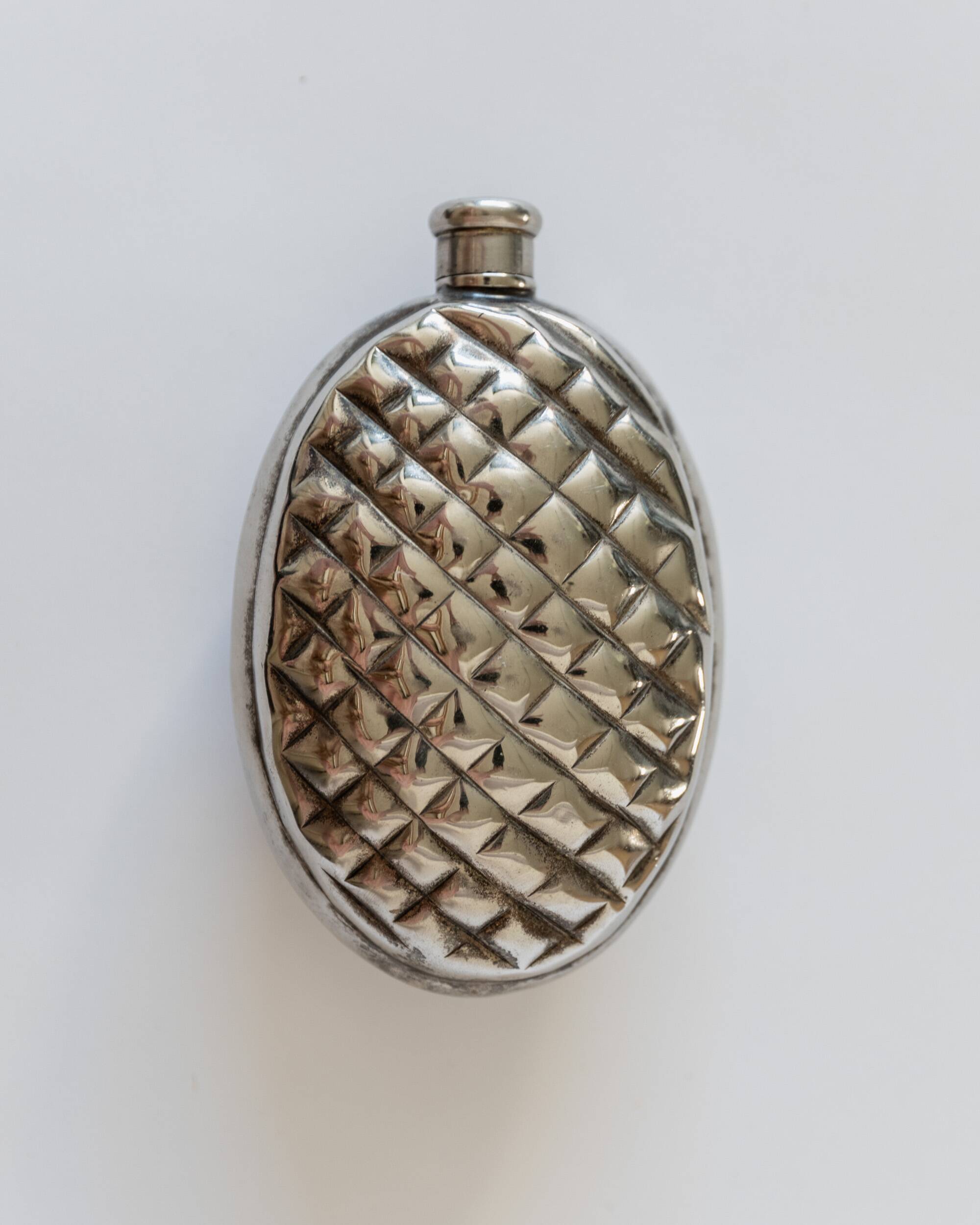 Vintage 1950s silver-plated flask in the shape of a pine cone.
